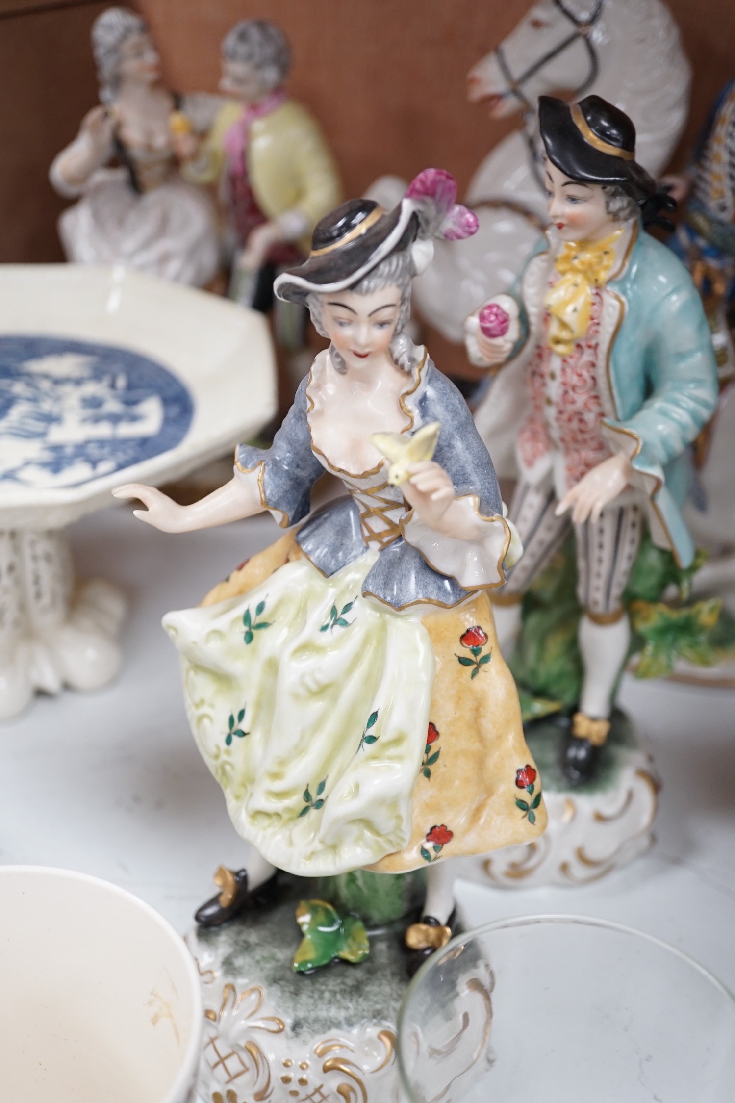 A group of porcelain figures, Doulton royal commemoratives, a Goebel Art Deco powder bowl and pin dollies etc (19)